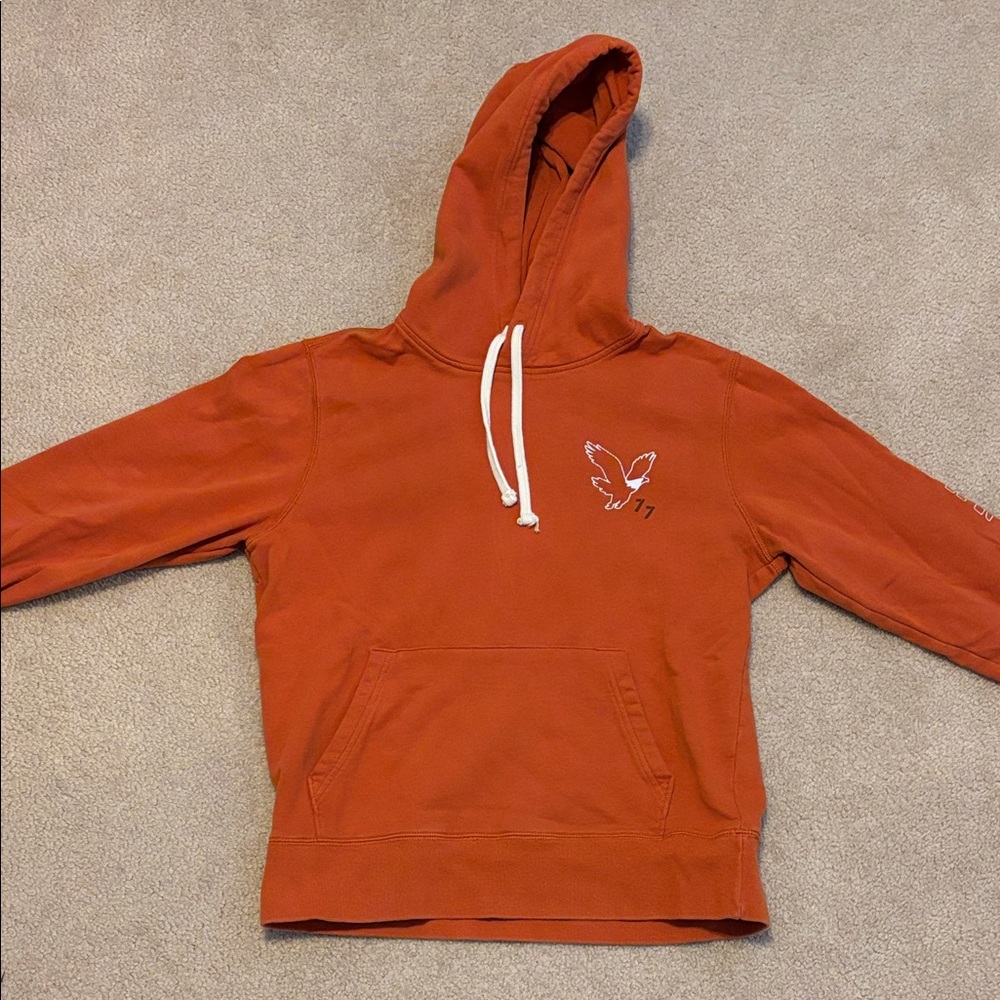 American Eagle Outfitters Orange Hoodie with brand name on sleeve.
